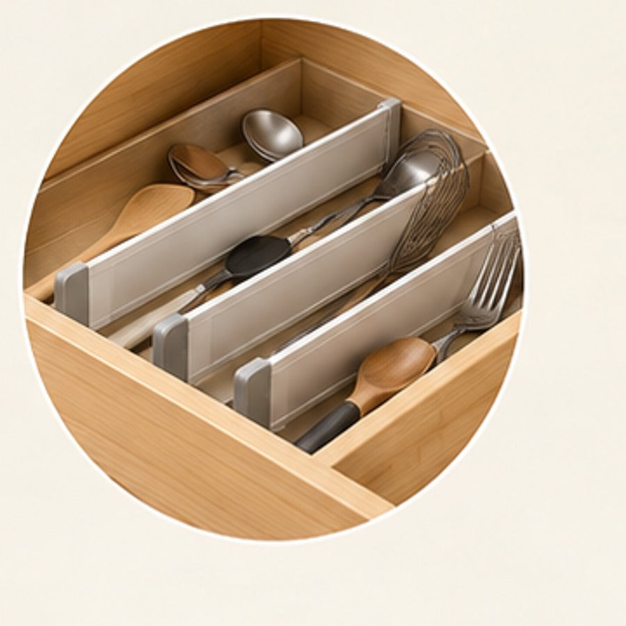 Adjustable drawer dividers shown organising utensils